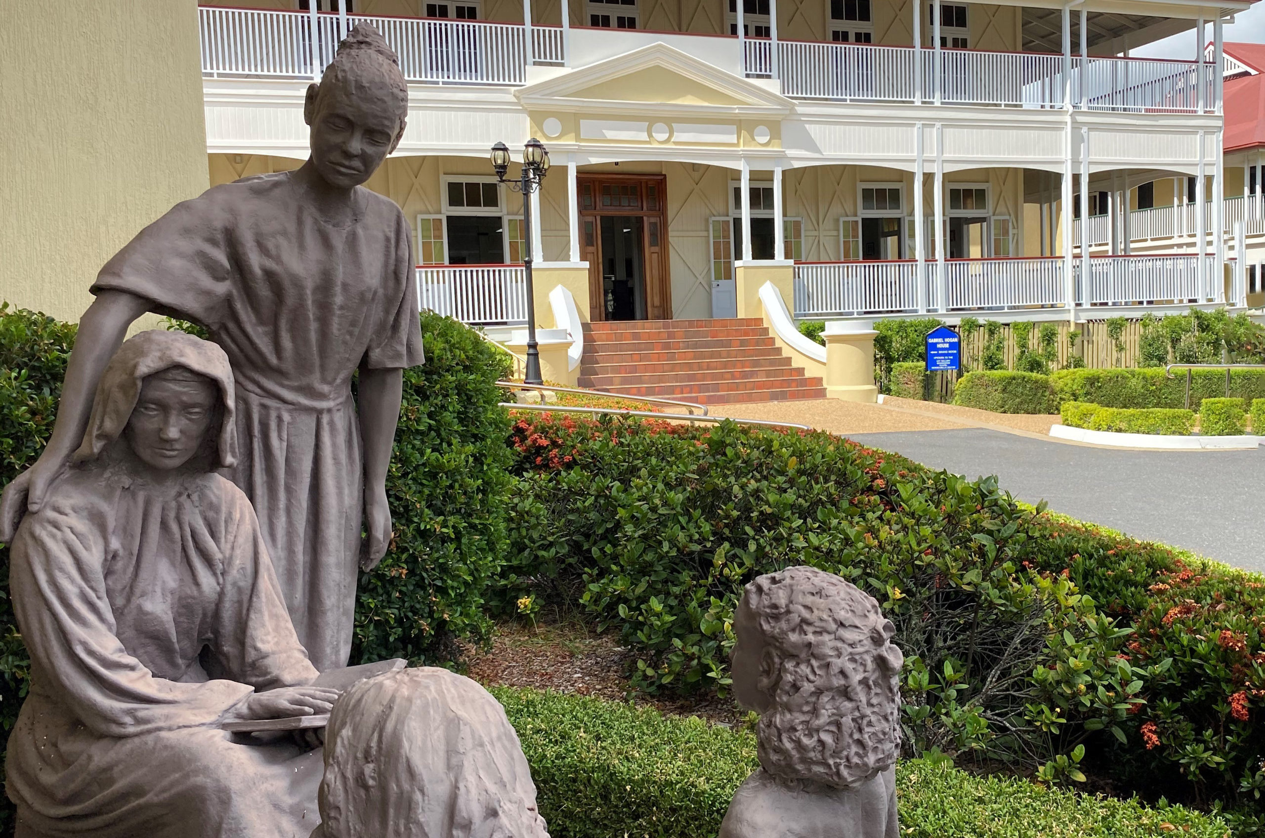 A statue of Nano Nagle and young women and girls surrounding her. The statue is located in the grounds of St Ursula's College.