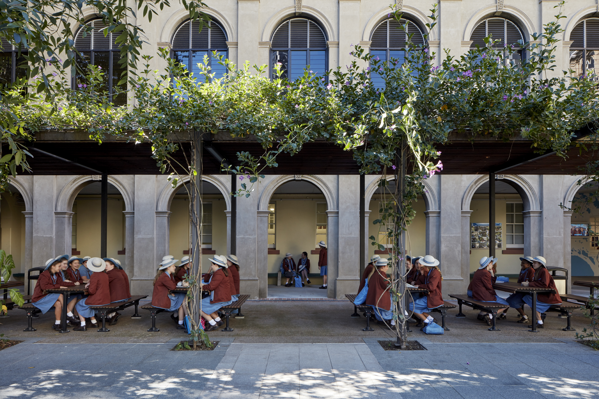 A photo of students from All Hallows' School sitting at outdoor tables.