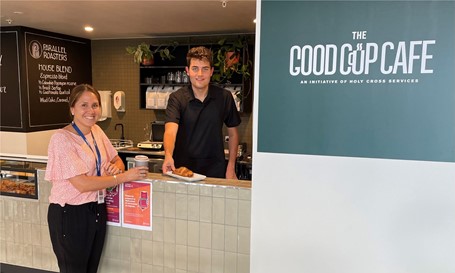 A picture of a lady purchasing a coffee from a young man who works at The Good Cup Cafe