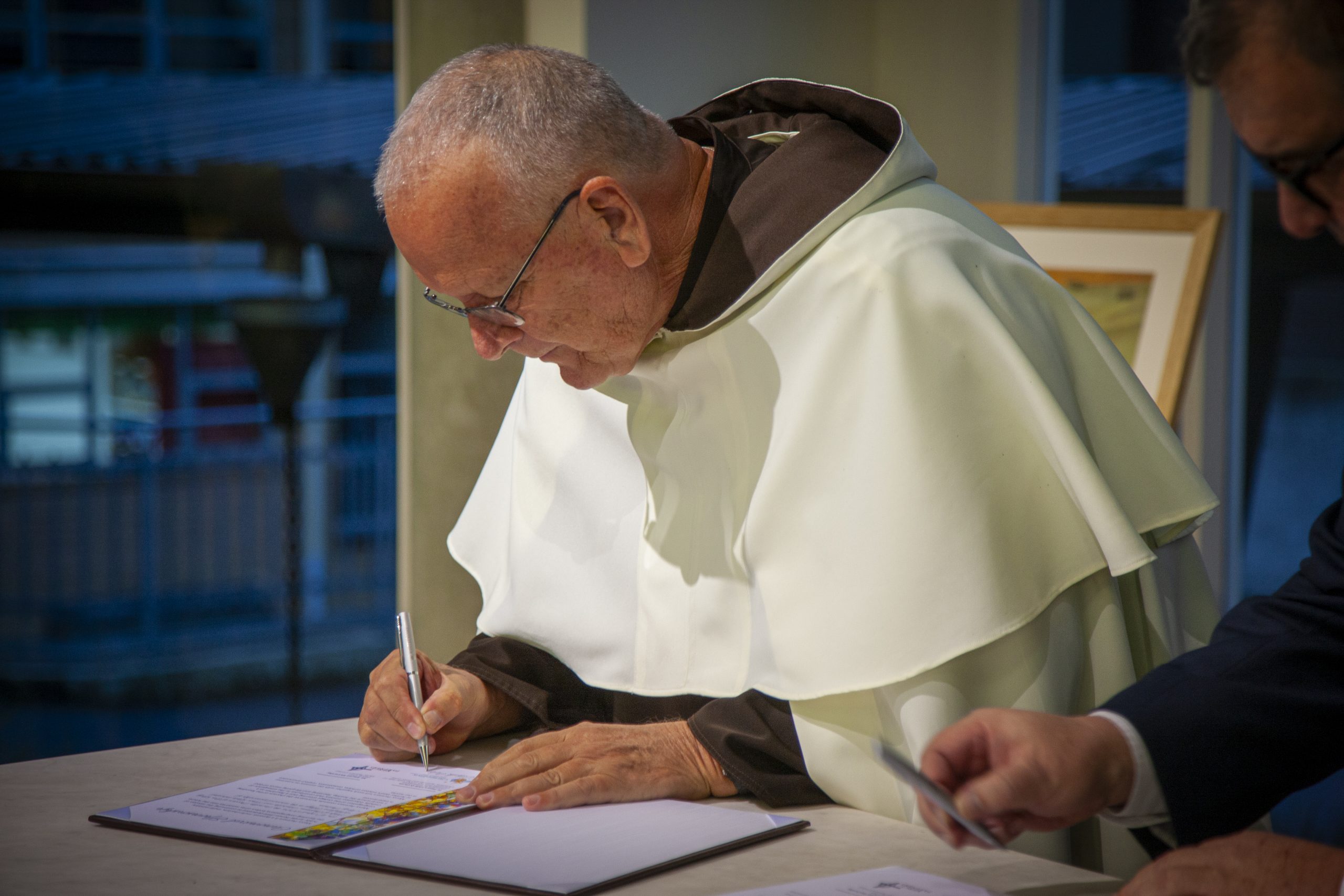 The signing of the Canonical Sponsorship certificate at the Whitefriars College transition ritual.