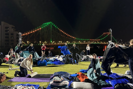 Students setting up their beds ready for their night in the open air.